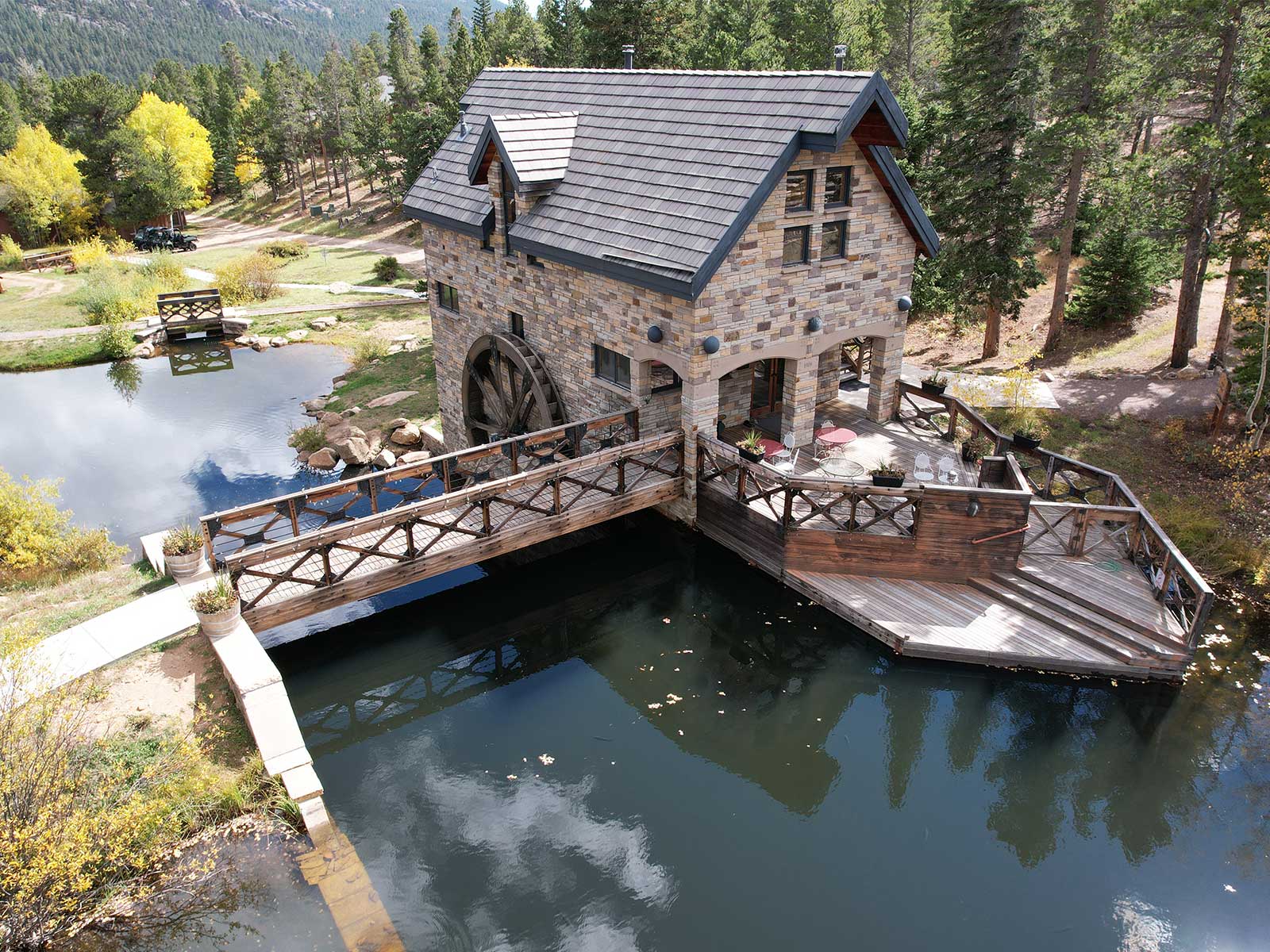 Water mill with trees and pond at The Salvation Army High Peak Camp Colorado