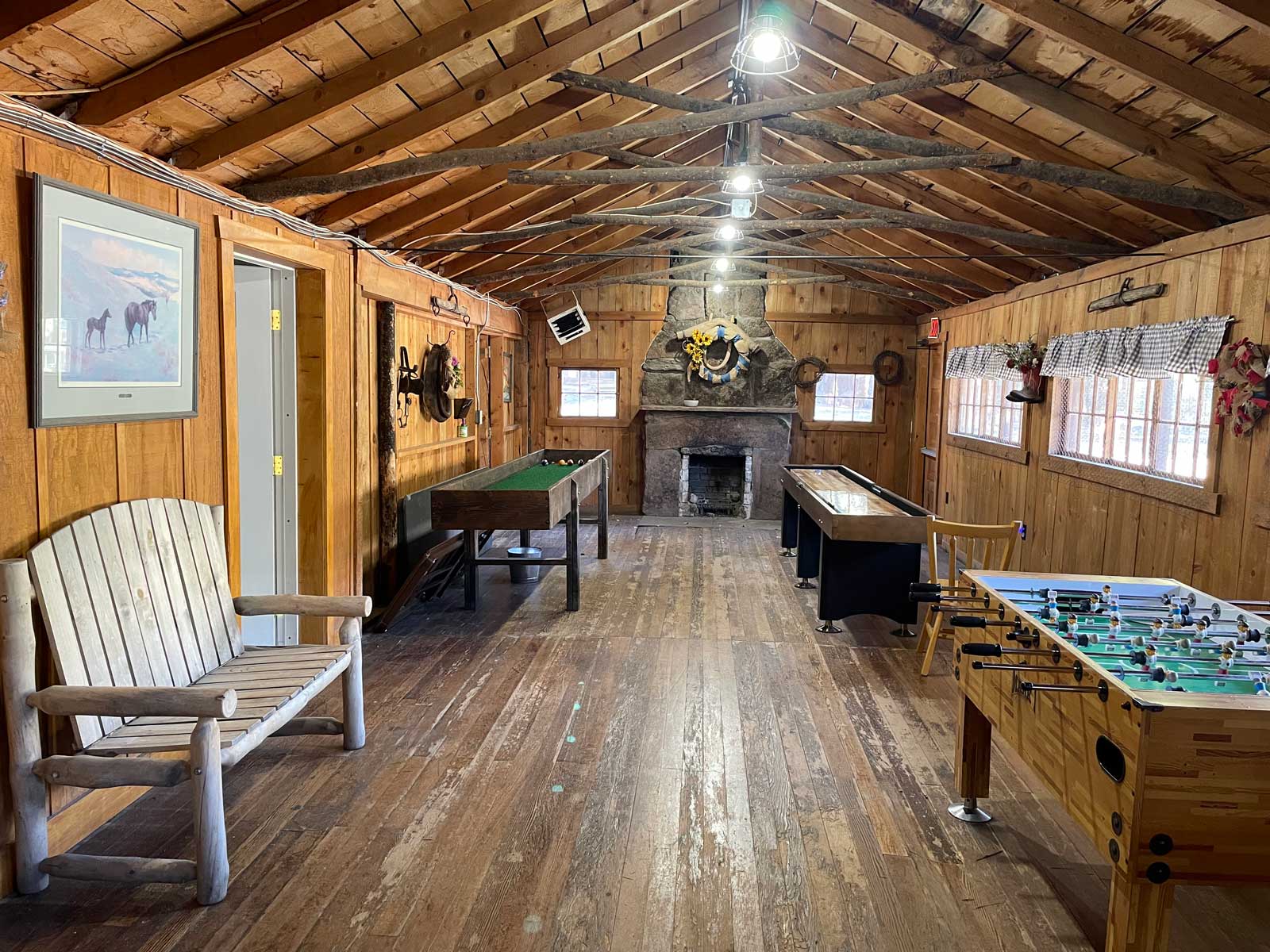 Room with antique bench pool table and table football at The Salvation Army High Peak Camp Colorado